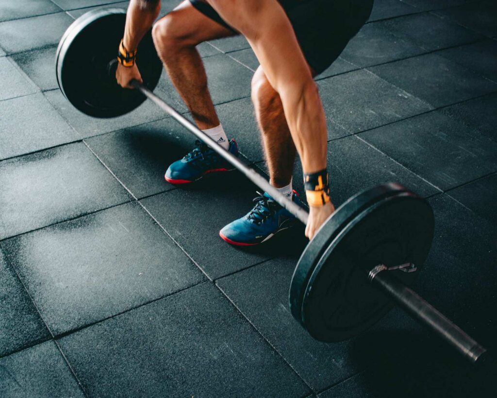 Man squatting using dumbbells